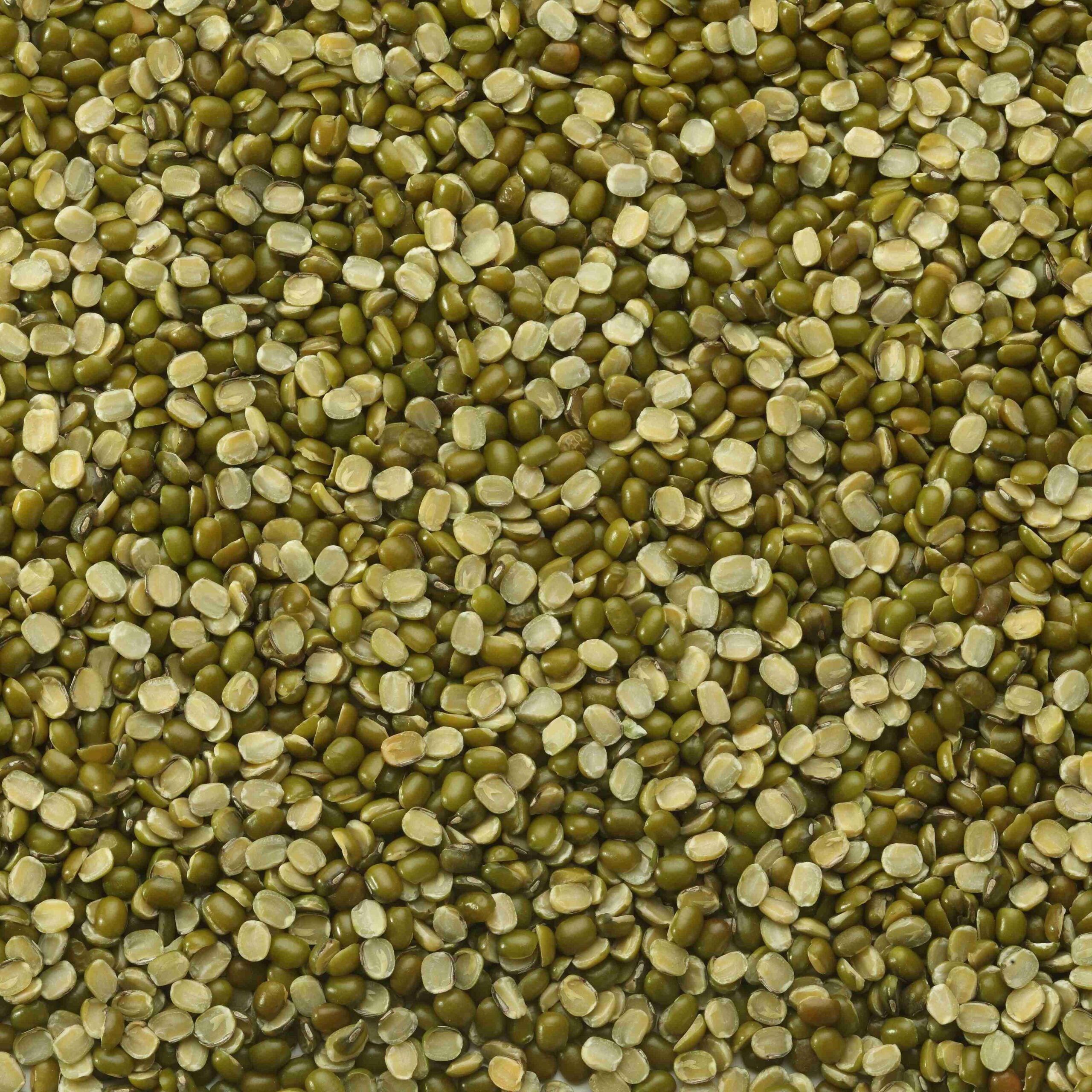Split unpeeled Moong Chilka beans in a clear bowl, showing their green color and natural texture, from Papagino Foods Inc.