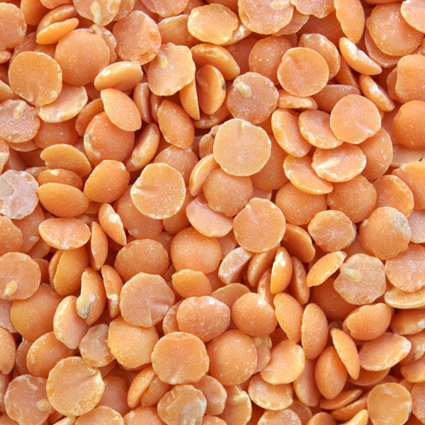 Red split lentils from Papagino Foods Inc. in a 10-pound bag, showcasing vibrant orange-red lentils ready for cooking.