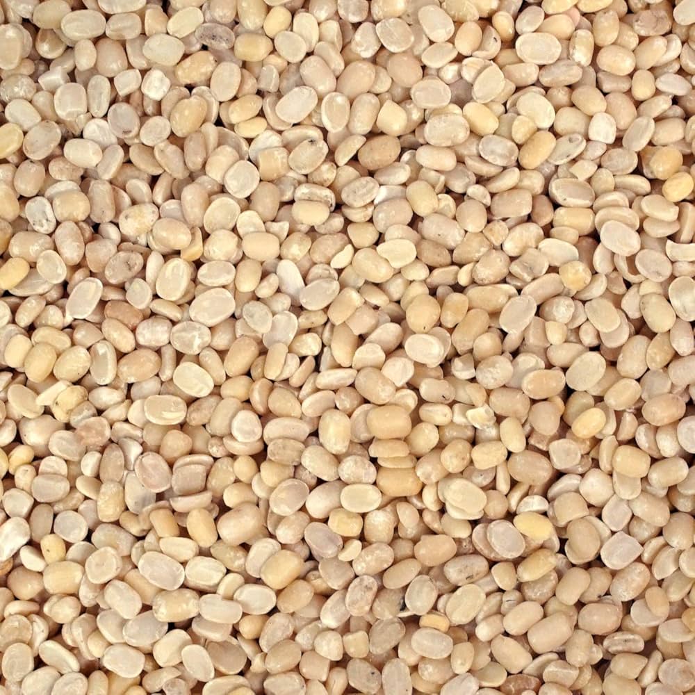 Peeled split Urid Dal from Papagino Foods Inc., a 25 kg bag of light beige lentils for cooking and Indian cuisine.